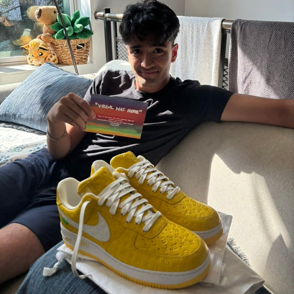 Person sitting on a couch with yellow sneakers in front of them, holding a colorful card.